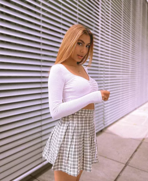 Innocent beauty in white top and skirt