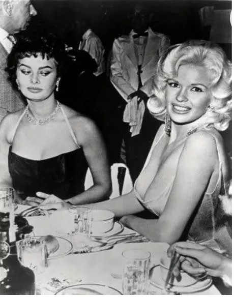 One of the first examples of breast envy. Sofia Loren gives side-eye to Jayne Mansfield’s ample bosom. One of the first examples of breast envy. Sofia Loren gives side-eye to Jayne Mansfield’s ample bosom.