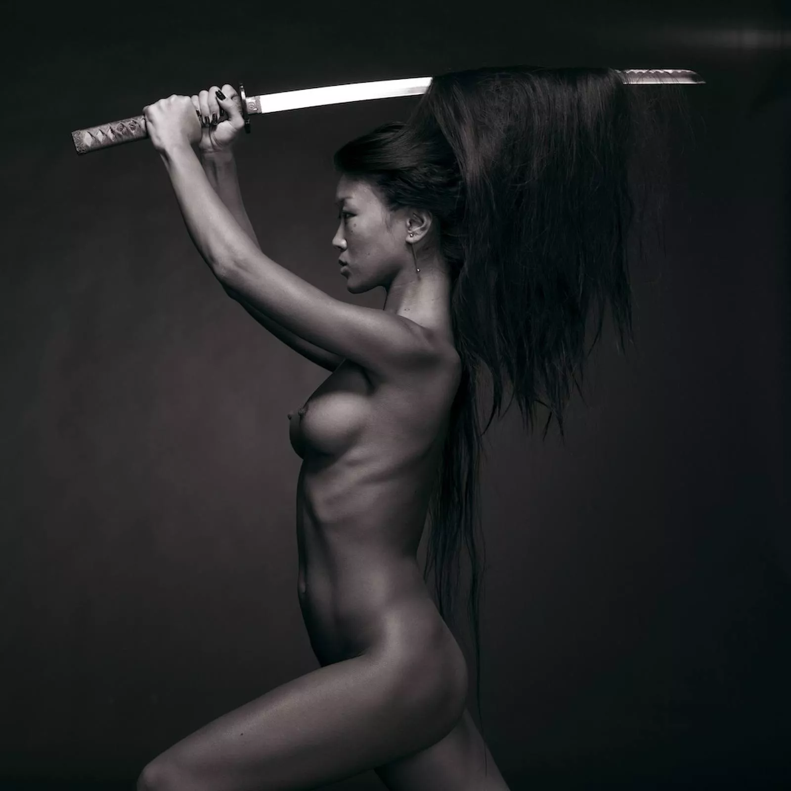 Asian woman wielding katana