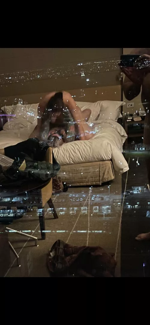 Wife riding a Bull at night at a luxury hotel with window wide open for all to see. My reflection is on top right, taking a photo as she orgasms moaning…