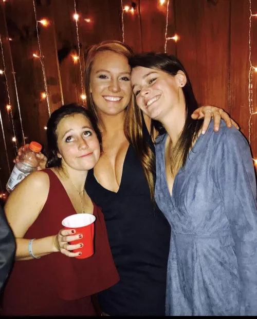 Girl in red using her friends chest as a head rest