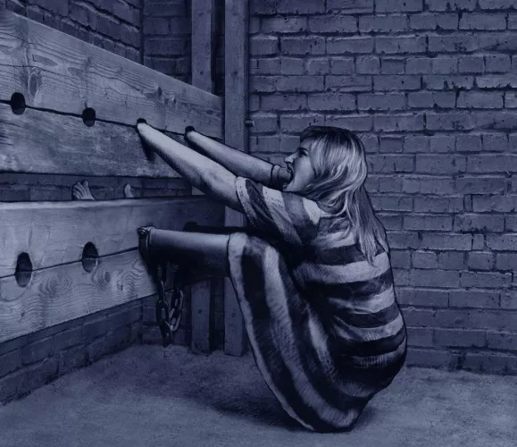 Locked in the stocks and still in ankle shackles