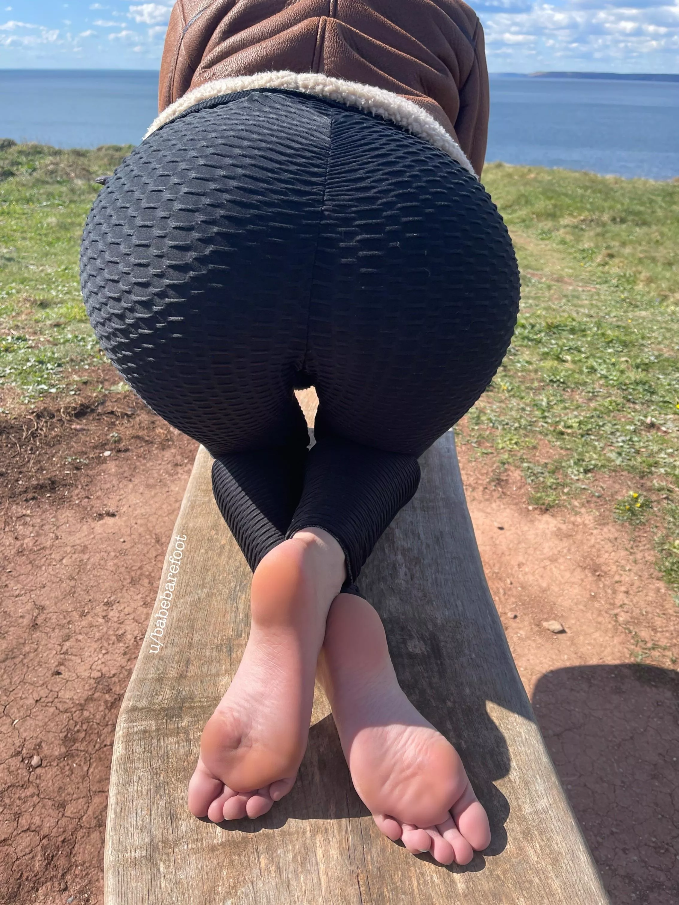 Crossed soles by the sea.