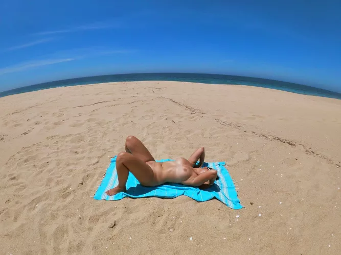 Doing naked yoga on the beach