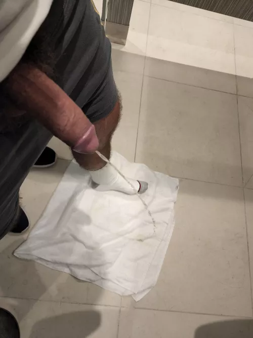 In a locker room preparing the towel to go to the sauna