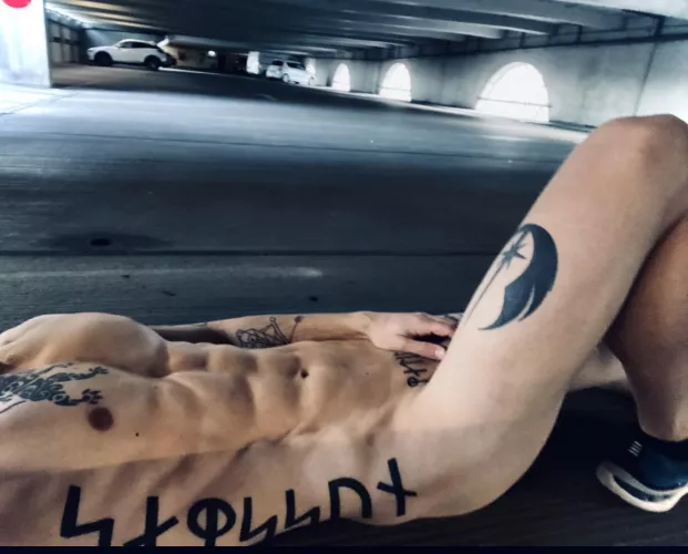 Lying naked in a car park. Sure i’m being watched