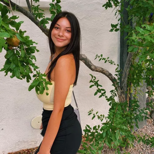 She’s trying to hide them behind a tree branch but she still can’t conceal them