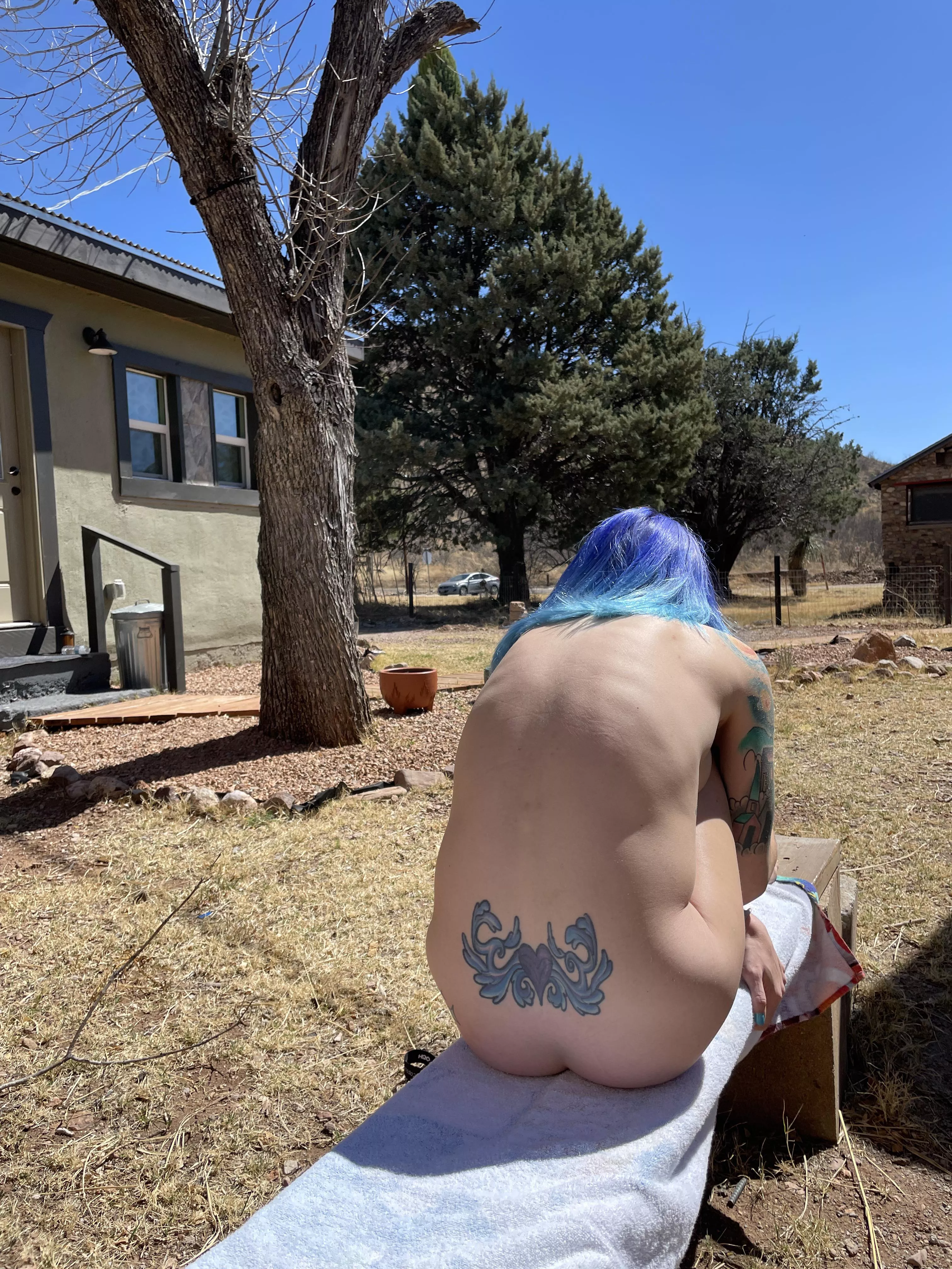 Tanning in the back yard, people could’ve caught a peek if they timed it right