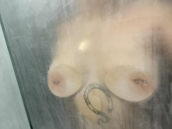 Tits on the glass during a hot shower