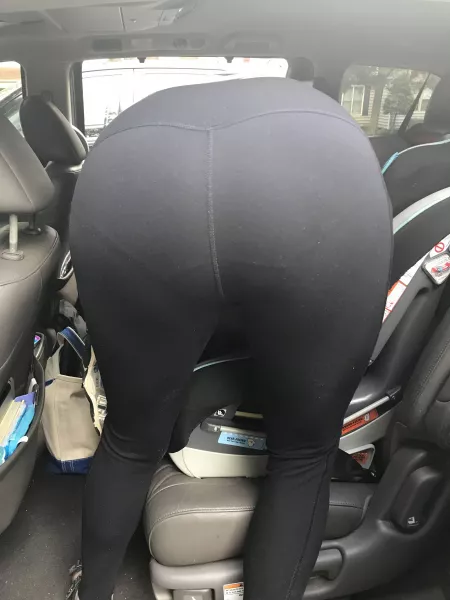 Showing off her panty lines while fixing the car seat. 😛